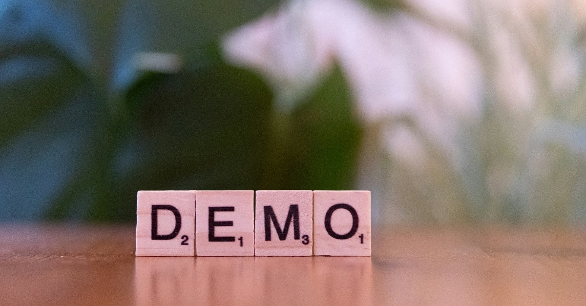 Scrabble tiles that spell the word "demo"